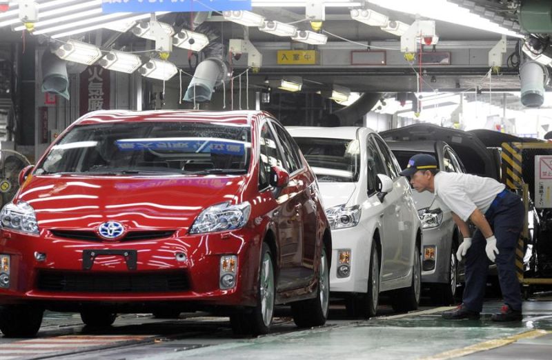 Trabajadores automotores japoneses inspeccionan autos híbridos Prius de Toyota Motor Corp., que salen de la línea de ensamblaje en la planta Tsutsumi del fabricante de automóviles en la ciudad de Toyota, provincia de Aichi, Japón. 